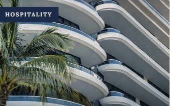 Hospitality property with curved balconies and palm trees